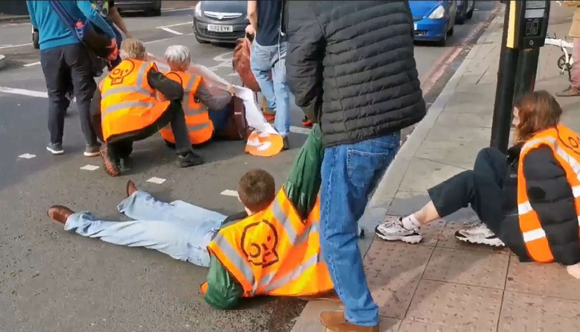 A member of the public dragging an activist off the street in October (Just Stop Oil/PA)