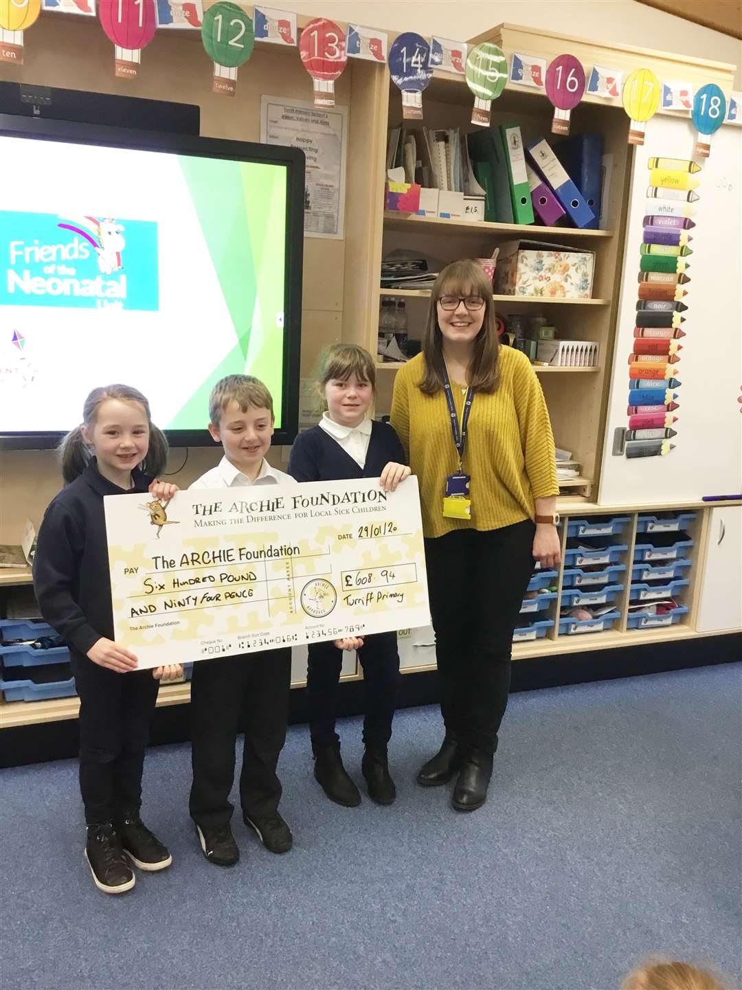 Isabella, Jenson and Emily handed over a cheque to Chloe Jackson from the Archie Foundation.