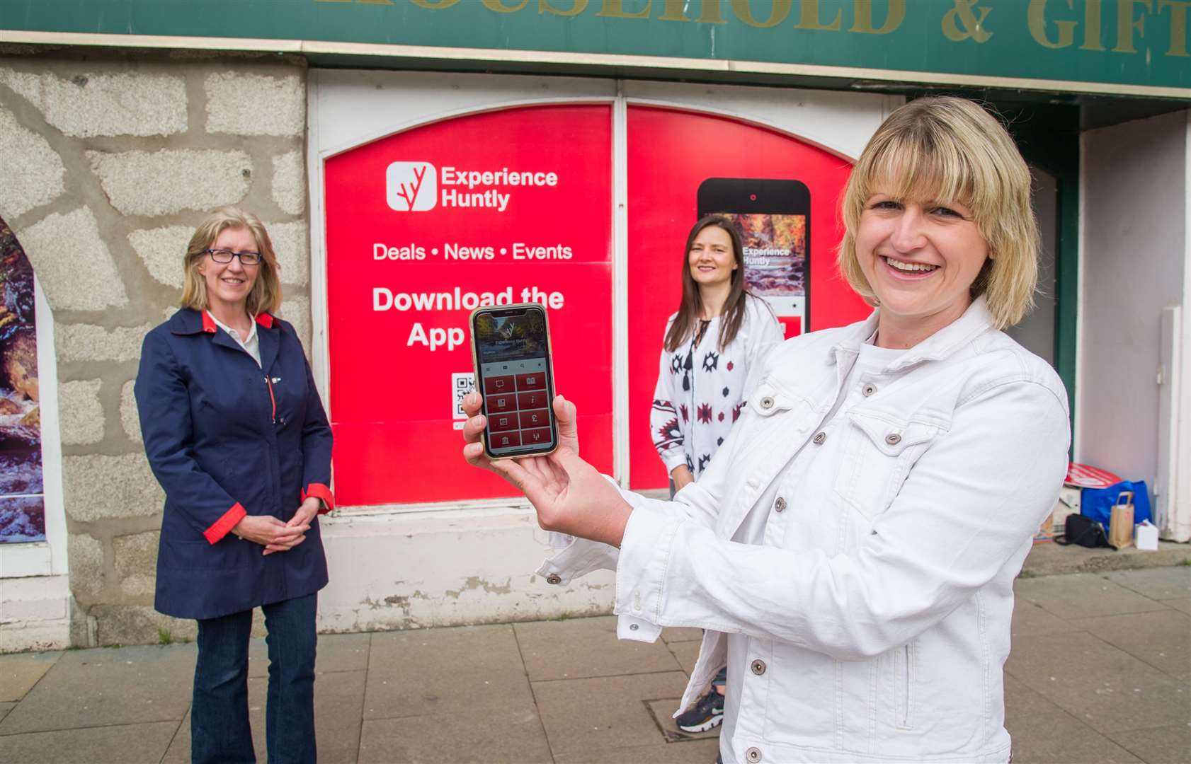 Vivien Rae shows the app on her mobile phone with Helen Kings and Laura McNeil. Picture: Becky Saunderson.