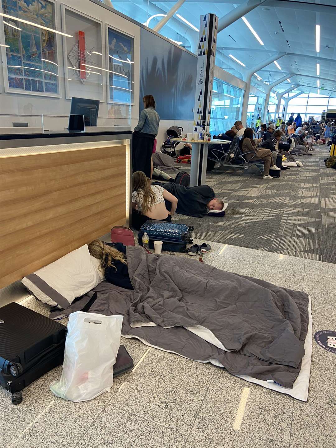 Like many others in the airport, the couple slept on the floor (Jonathan Lo/PA)