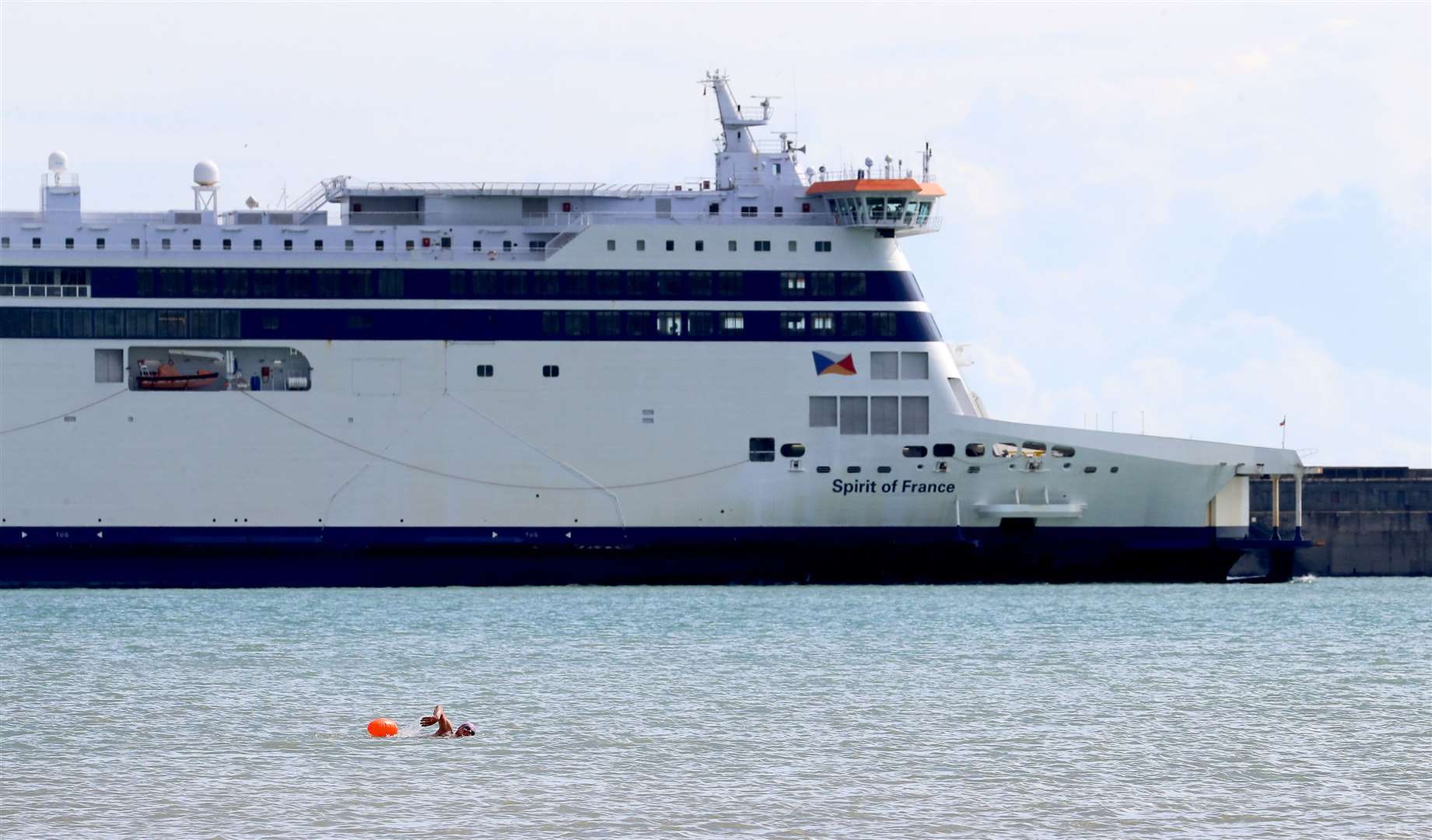 The RNLI has urged people to take care in water when Storm Francis arrives, as an open water swimmer passes the P&O Spirit of France ferry in the Port of Dover in Kent (Gareth Fuller/PA)