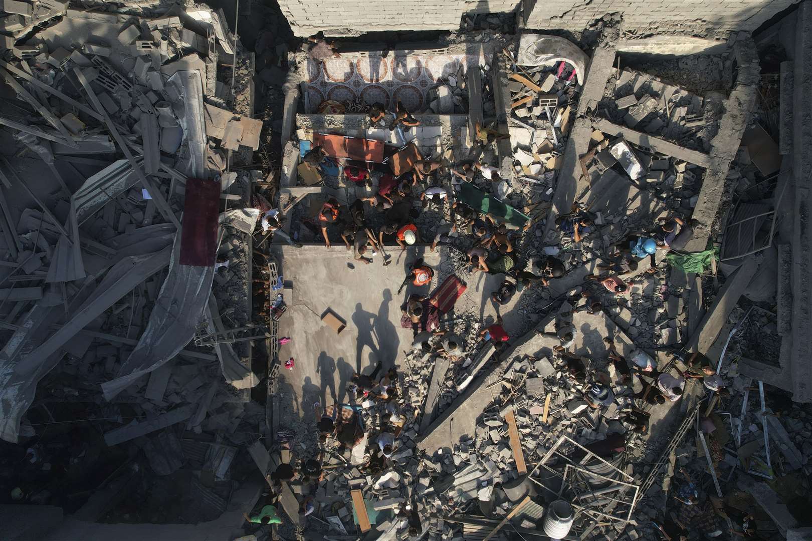 Palestinians inspect the rubble of buildings hit by an Israeli airstrike at Al Shati Refugee Camp (AP Photo/Hatem Moussa)