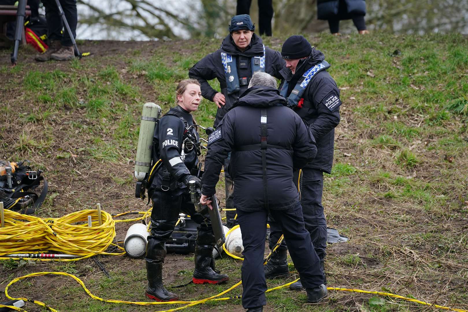 Specialist search teams from Lancashire Police on the banks of the River Wyre (Peter Byrne/PA)