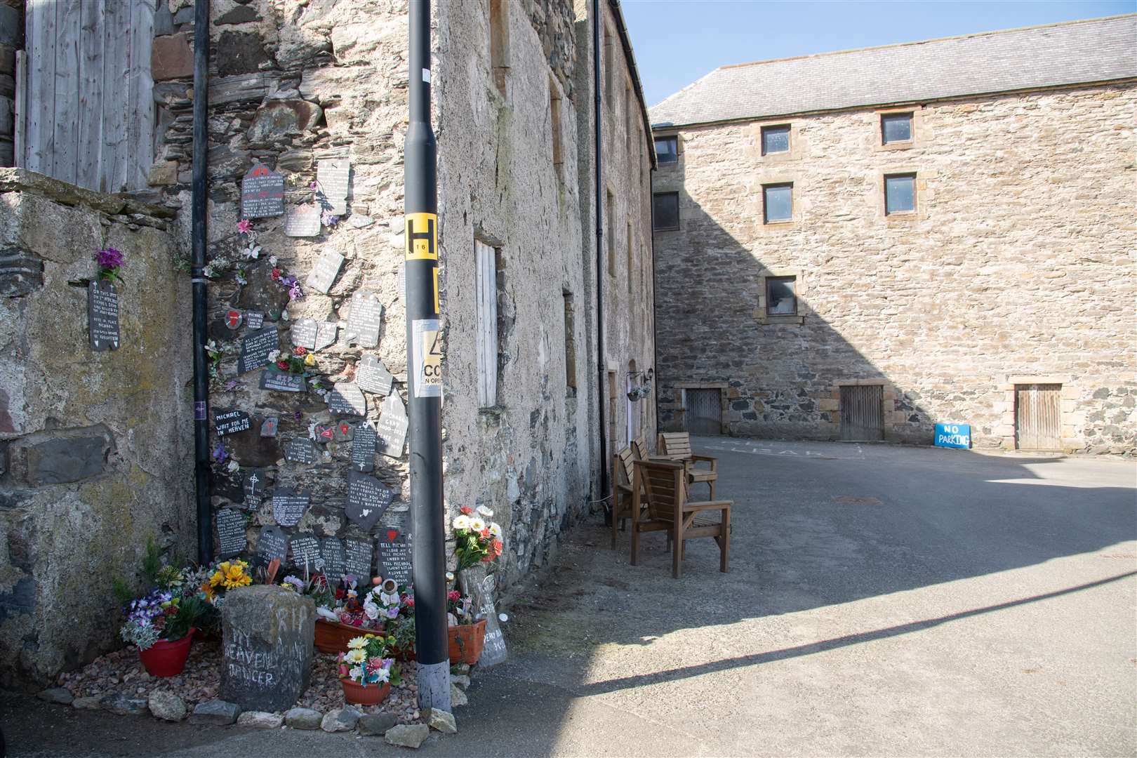 Written and floral tributes to Michael Gray in Portsoy. Picture: Daniel Forsyth