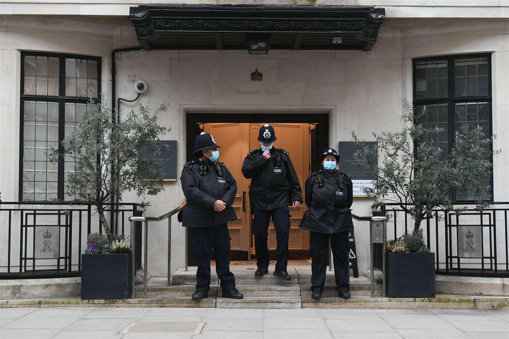 Police officers stand at the entrance to the King Edward VII Hospital (Dominic Lipinski/PA)