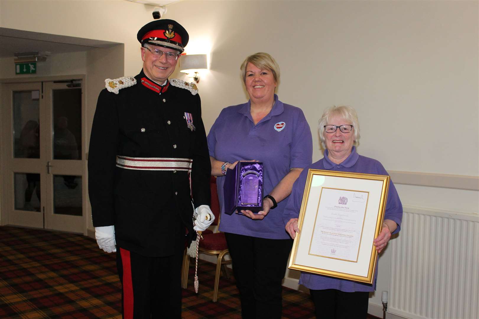 Lord-Lieutenant of Banffshire Andrew Simpson presents the accolade to chairwoman Shona Lyon and long-serving volunteer Lorna French. Picture: Kyle Ritchie