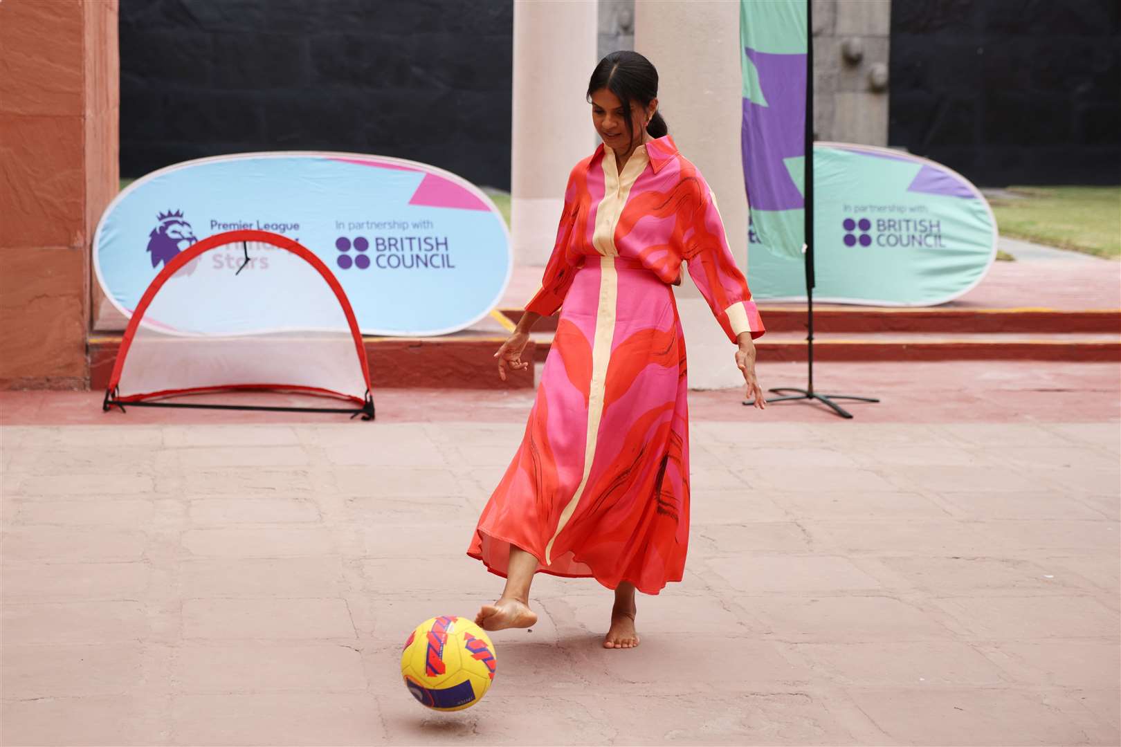 Akshata Murty took off her shoes to play football with children at the British Council in New Delhi (Dan Kitwood/PA)