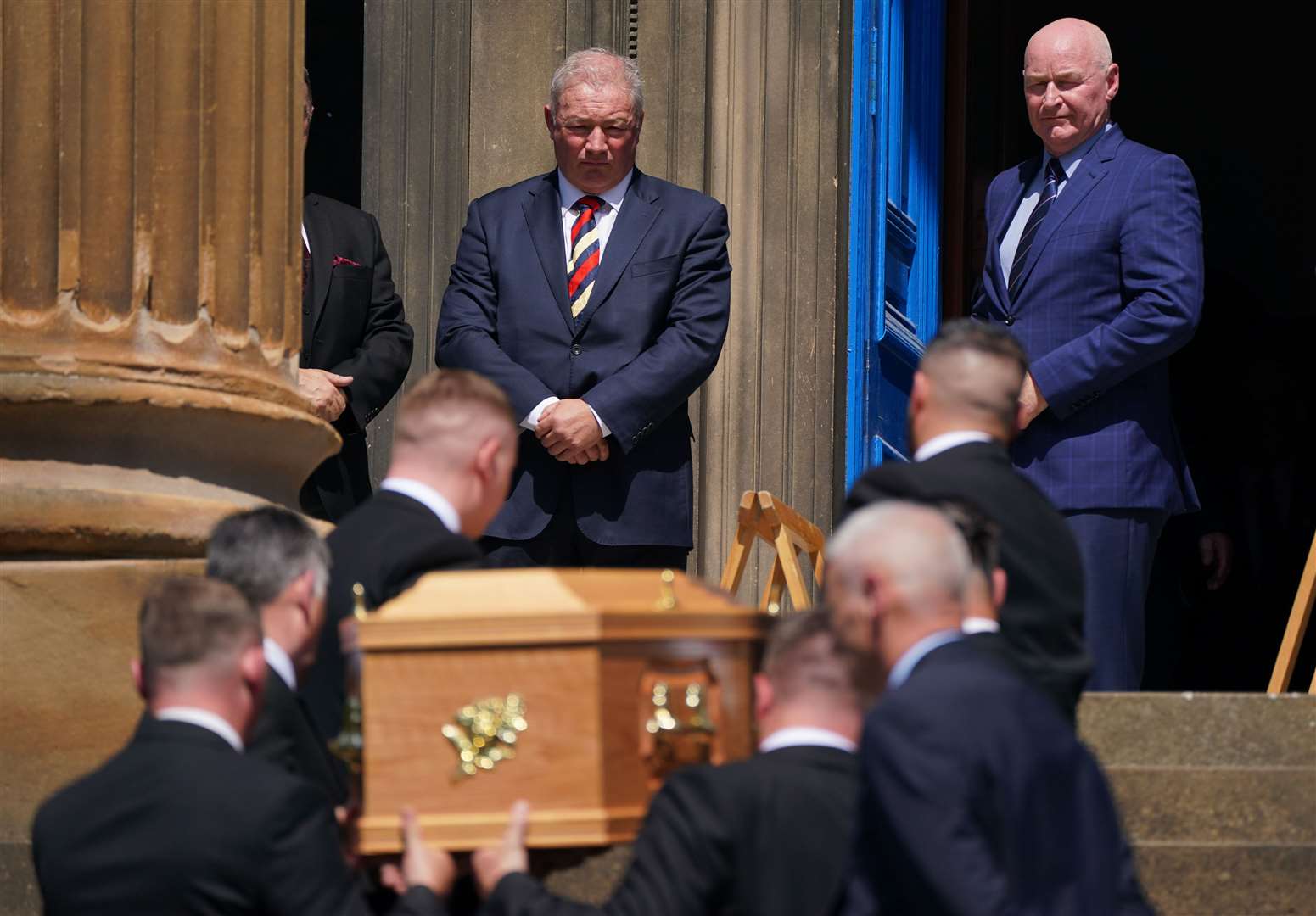 Former Rangers players Ally McCoist and John Brown watch the coffin arrive ahead of the funeral service (Andrew Milligan/PA)