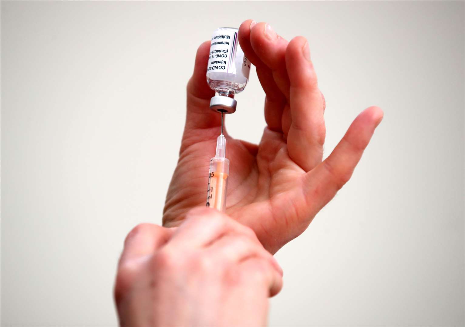 Dr Jennie Bailey fills a syringe with a dose of the Oxford/AstraZeneca coronavirus vaccine (Nick Potts/PA)