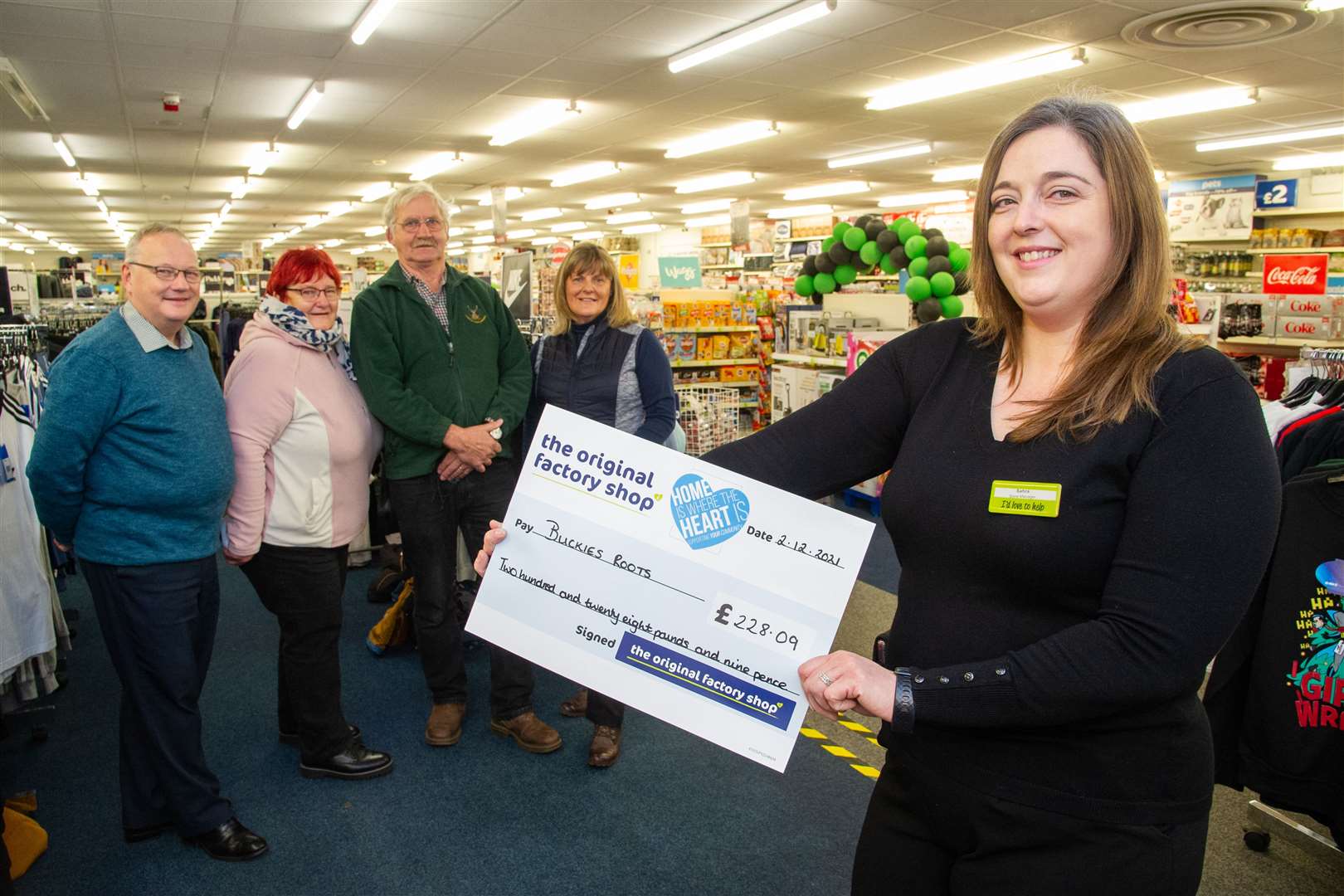 Buckie Factory Shop manager Sahra Taylor presents a cheque for £228.09 to (from left) Gifford Leslie, Meg Jamieson, Archie Jamieson and Sandra Simpson from Buckie's Roots. Picture: Daniel Forsyth