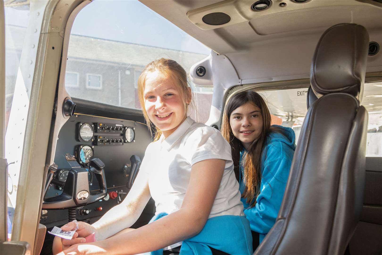 From left: Megan Jamieson and Ellie-Mai Simpson sitting in the cockpit from Mission Aviation Fellowship at Keith Grammar School...Picture: Beth Taylor.