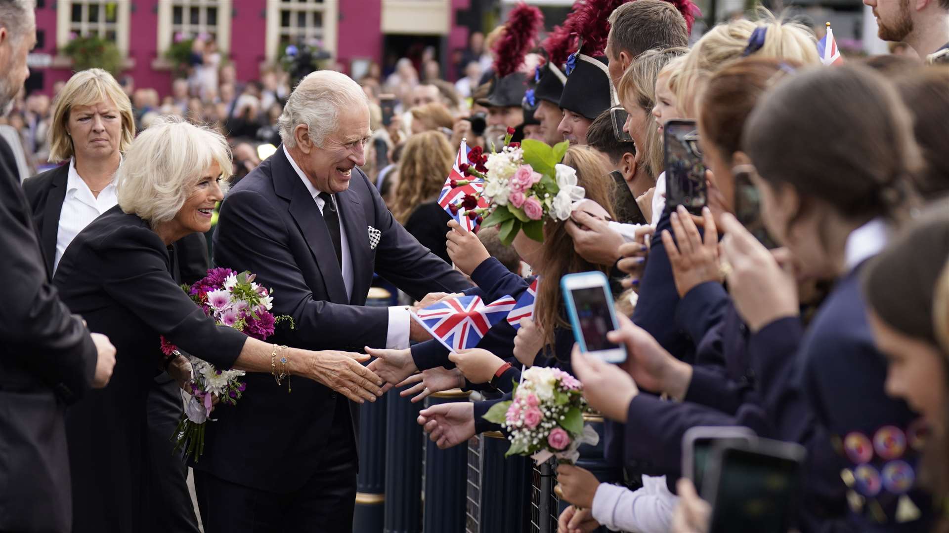 Charles and Camilla speak to people in the crowd (Niall Carson/PA)