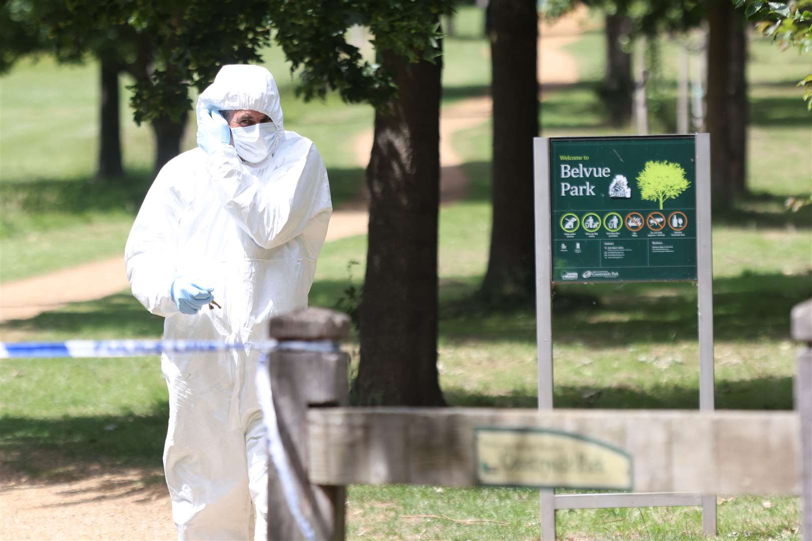 An officer at Belvue Park where the body of a man was found on fire in the early hours of Monday (James Manning/PA)