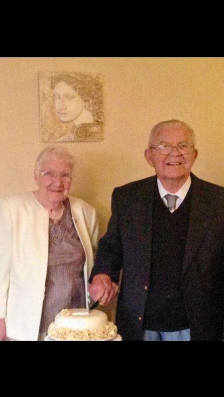 Mina and James Lownie cut a cake to mark their 75 years of marriage.