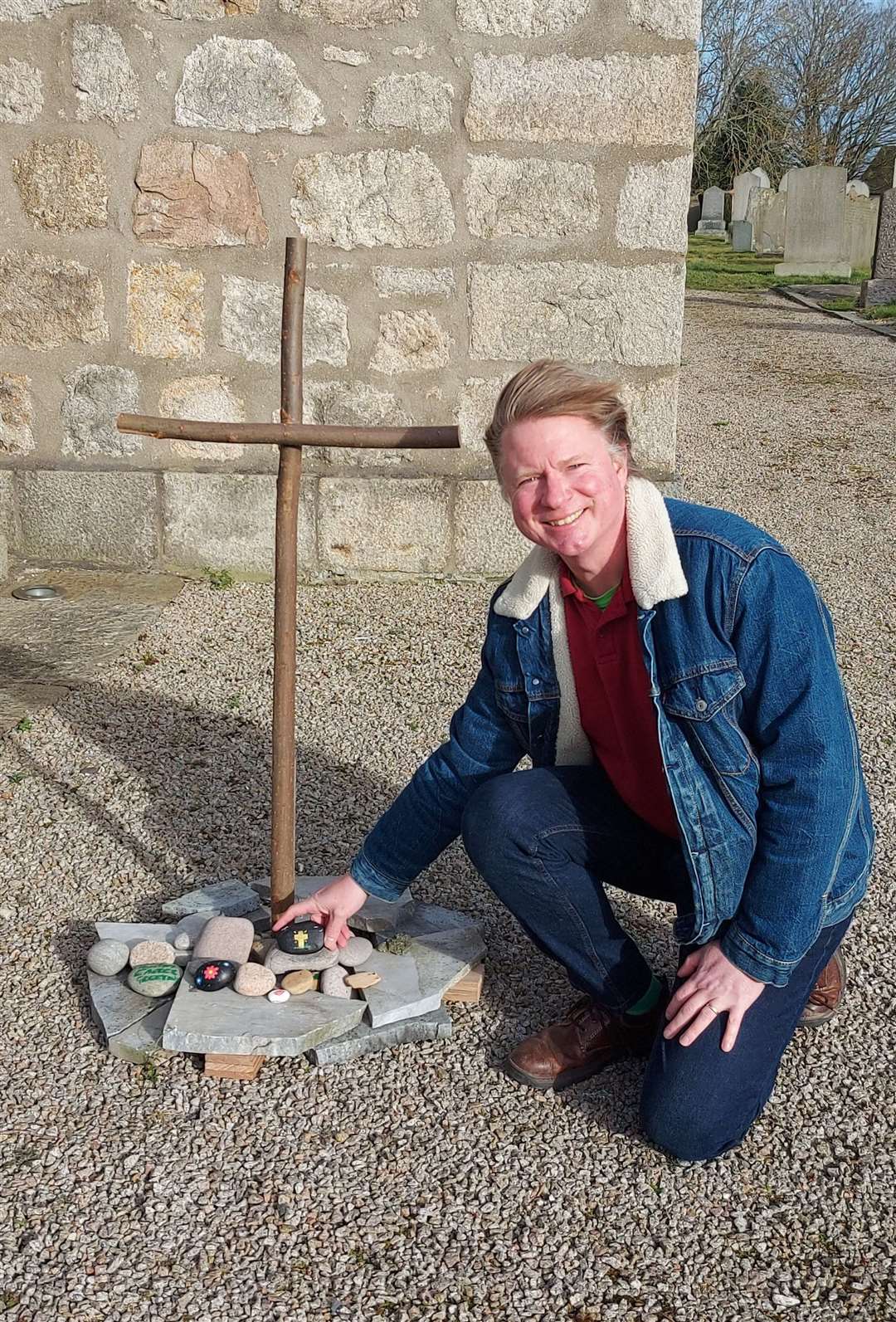 Rev Neil Meyer at the Easter cairn which has been created in the grounds of Kintore Parish Church.