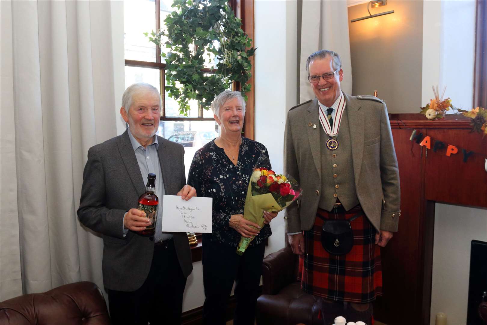 Noni and Douglas Pirie were presented with gifts by Deputy Lord Lieutenant of Aberdeenshire Major Grenville Irvine-Fortescue . Picture: David Porter