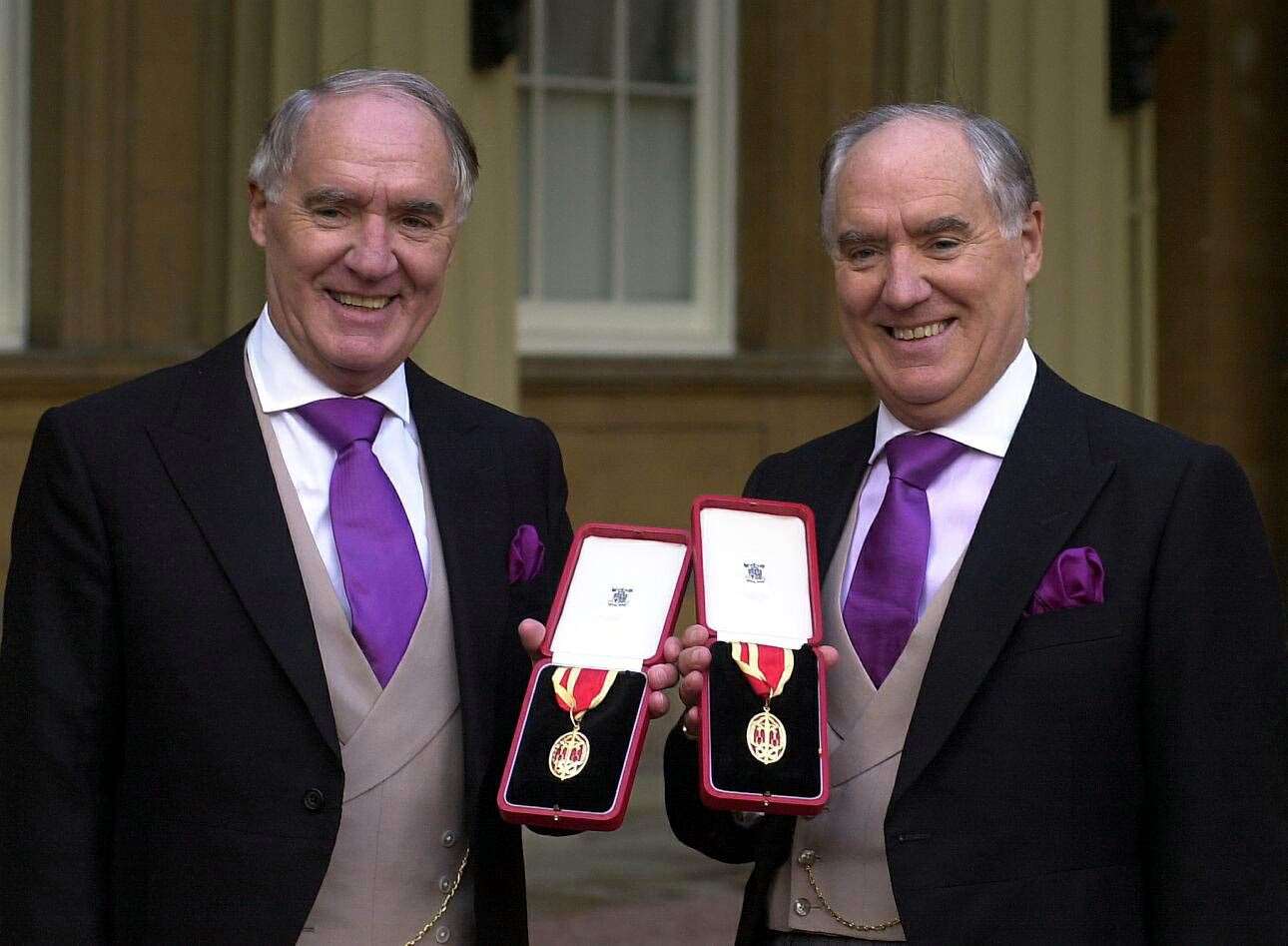 Sir Frederick Barclay, right, and his twin brother, Sir David, after receiving their knighthoods in 2000 (Michael Stephens/PA)