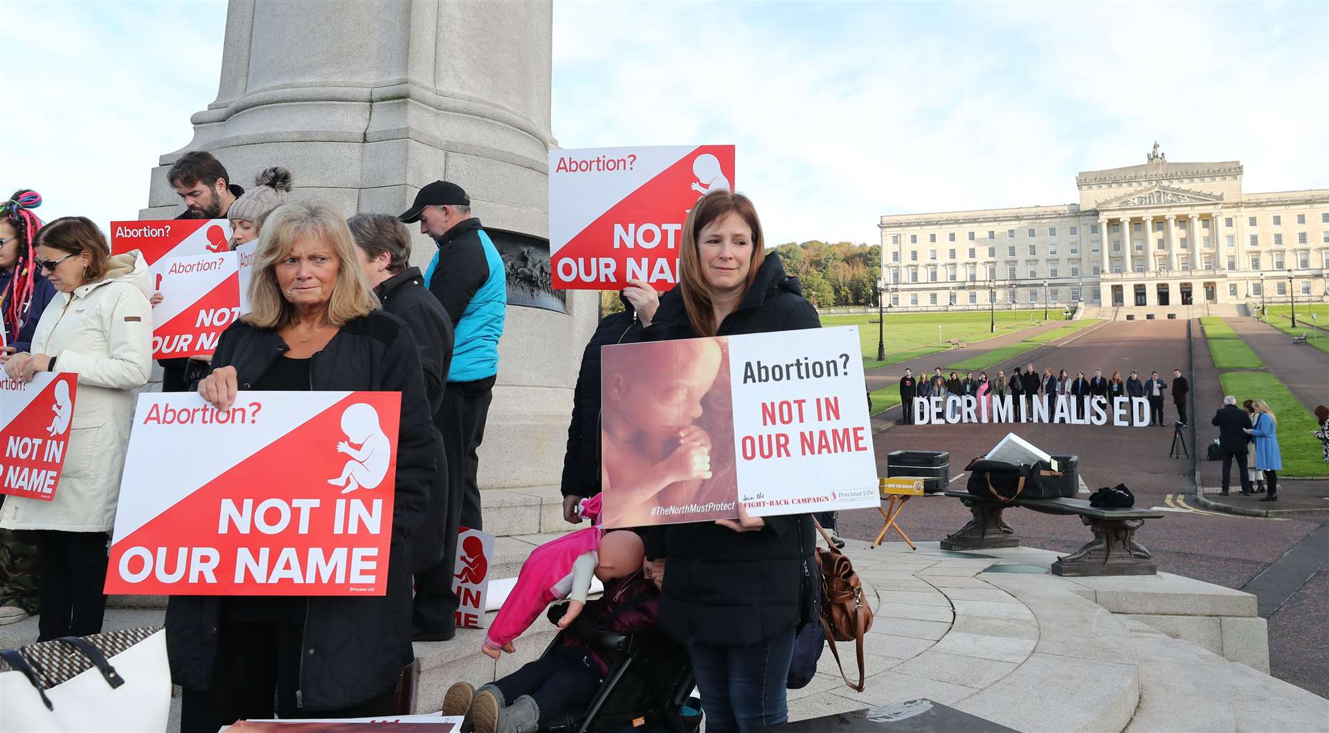 Anti-abortion and pro-choice activists take part in separate protests at Stormont (PA)