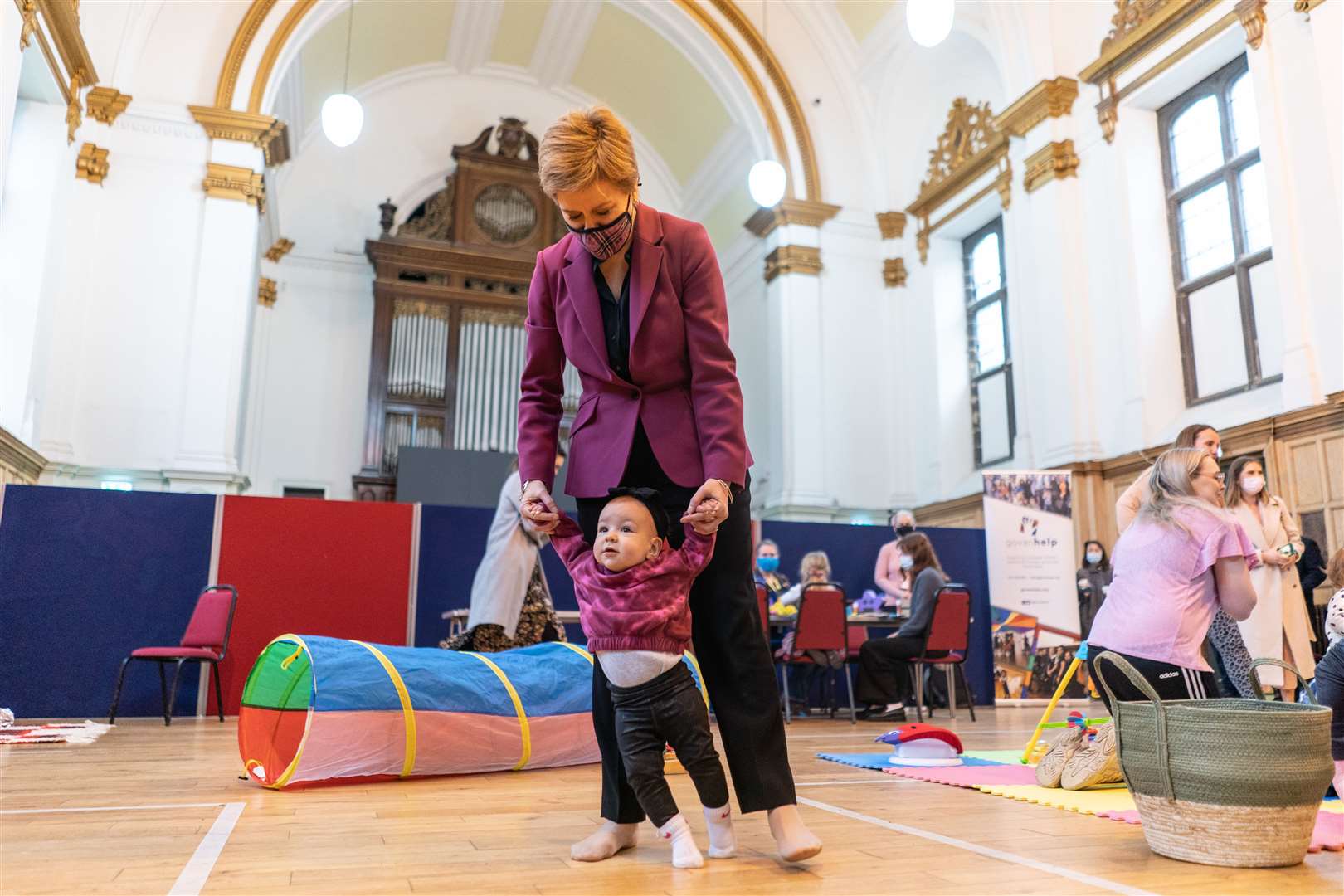First Minister Nicola Sturgeon with nine month old Amelia Mackinnon as she meets families at Govan Help in Glasgow, a charity supporting vulnerable families, to mark the doubling of the Scottish Child Payment in April this year (Peter Summers/PA)