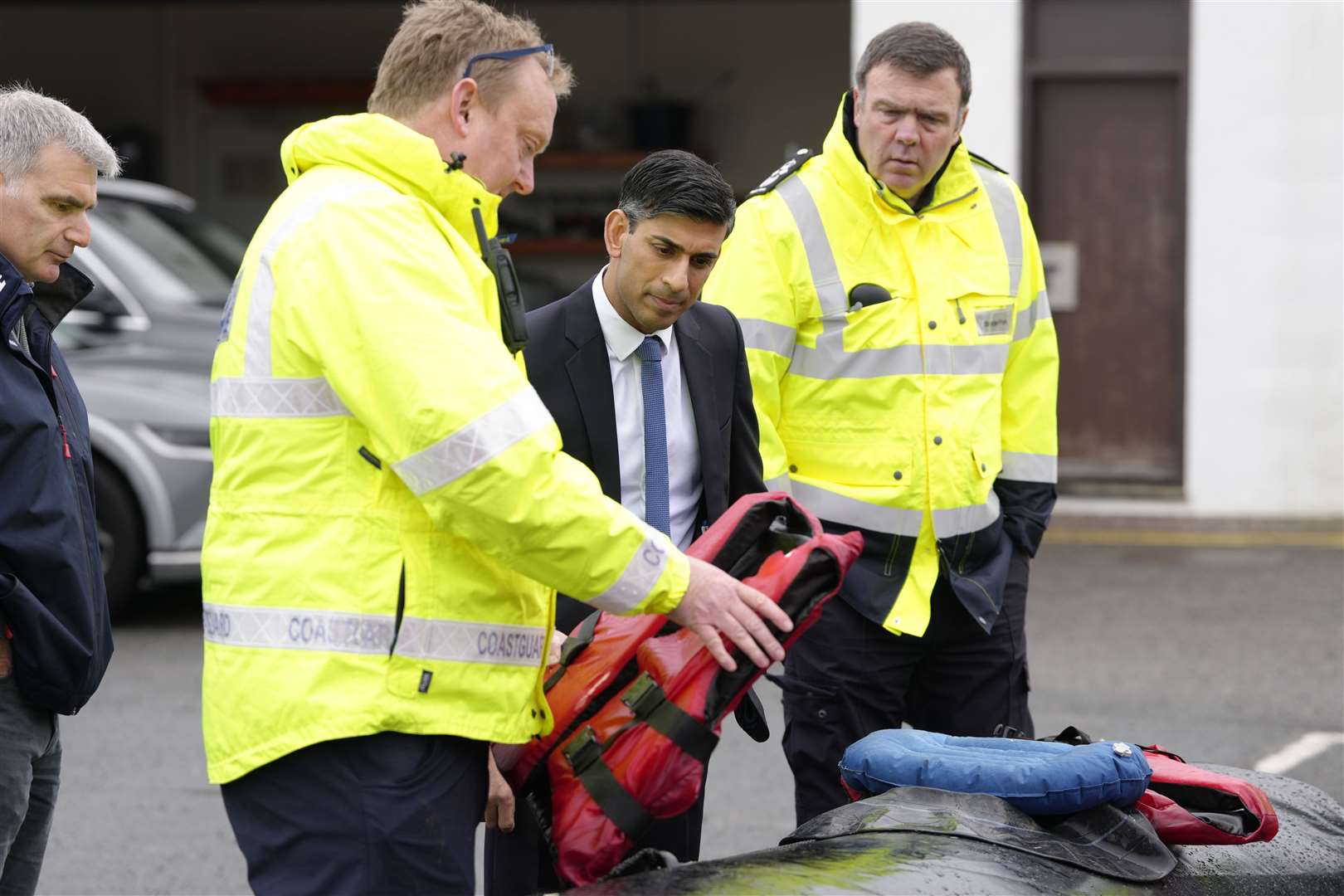 Prime Minister Rishi Sunak speaks with staff as he views a rubber dinghy and life vests during a visit to the Home Office joint control centre in Dover (Kirsty Wrigglesworth/PA)