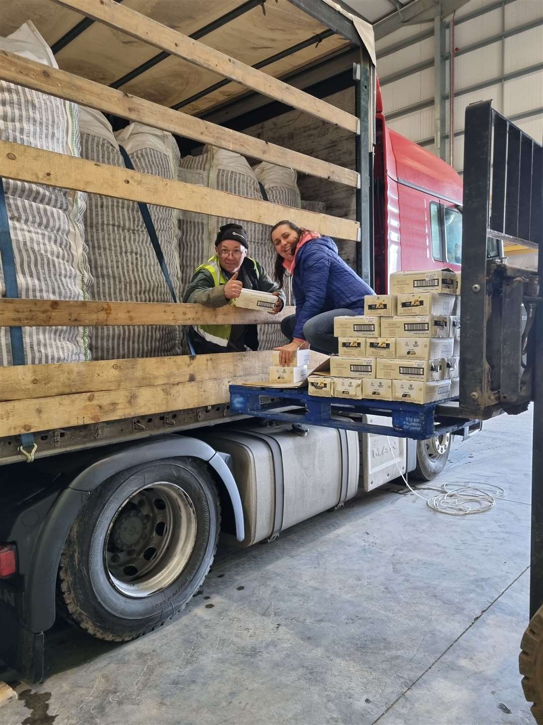 Gray farms store manager Barry Davidson and Adrianna Sosnowska packing the shortbread donations from Deans onto the lorry.