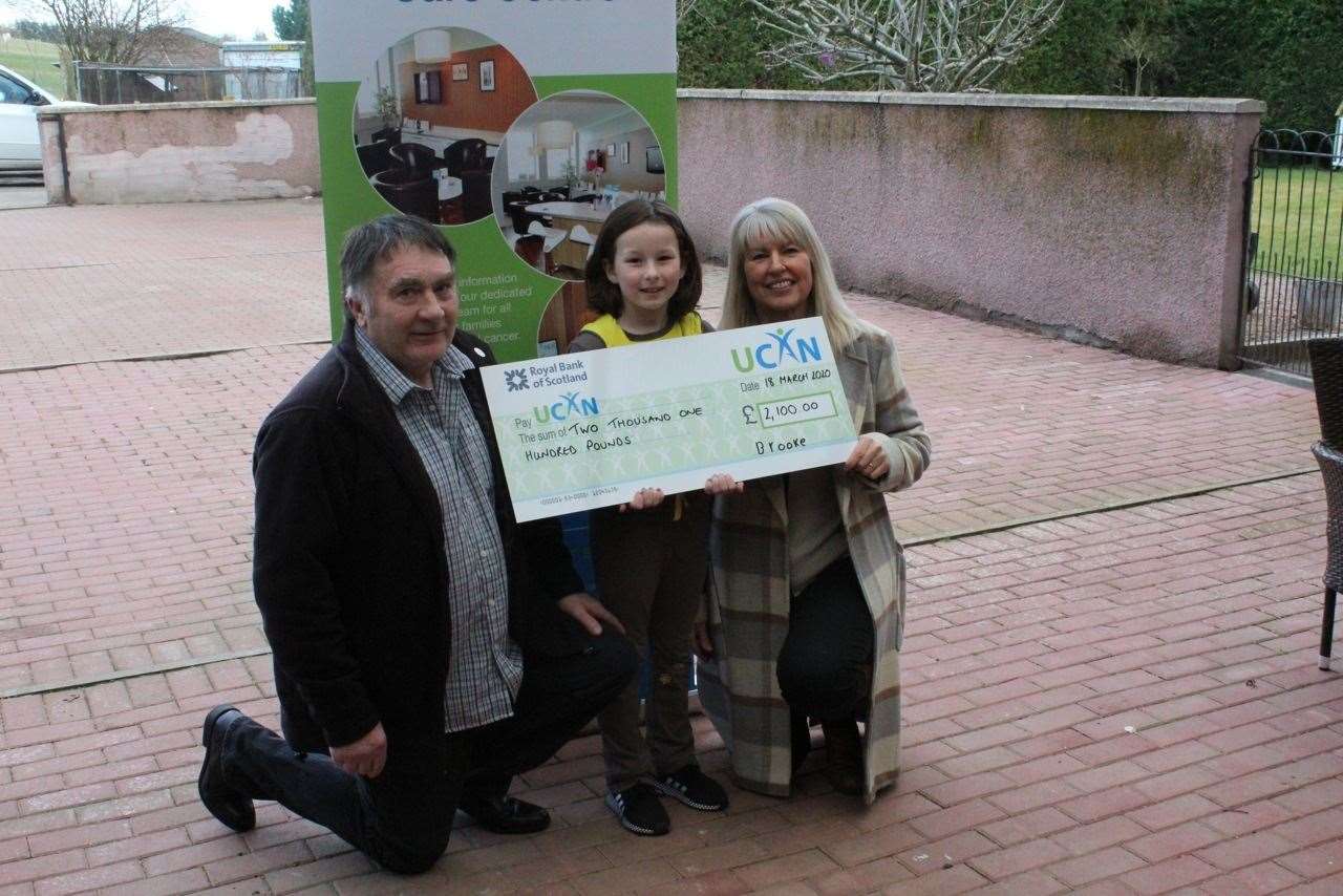 Brooke Fraser, grandad Ian and UCAN’s Gayle Stephen with the cheque.