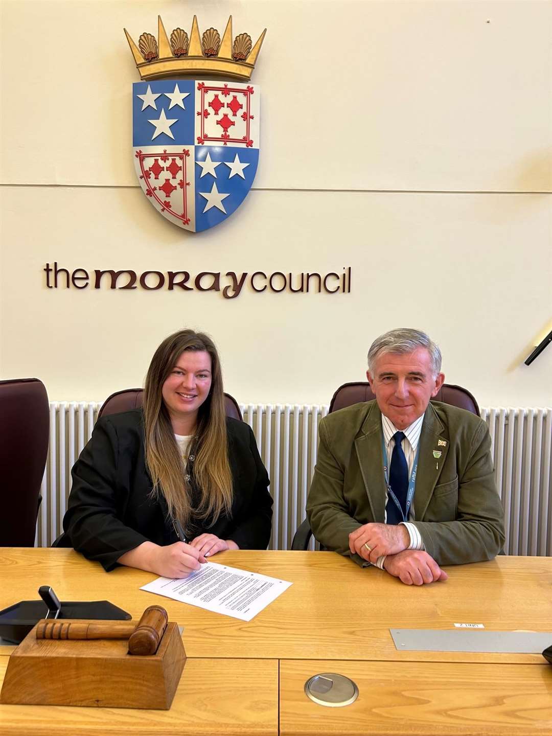 Housing and community safety committee chair Councillor Amber Dunbar and vice-chair, Councillor Donald Gatt, sign Moray Council's annual assurance statement. Picture: Moray Council.