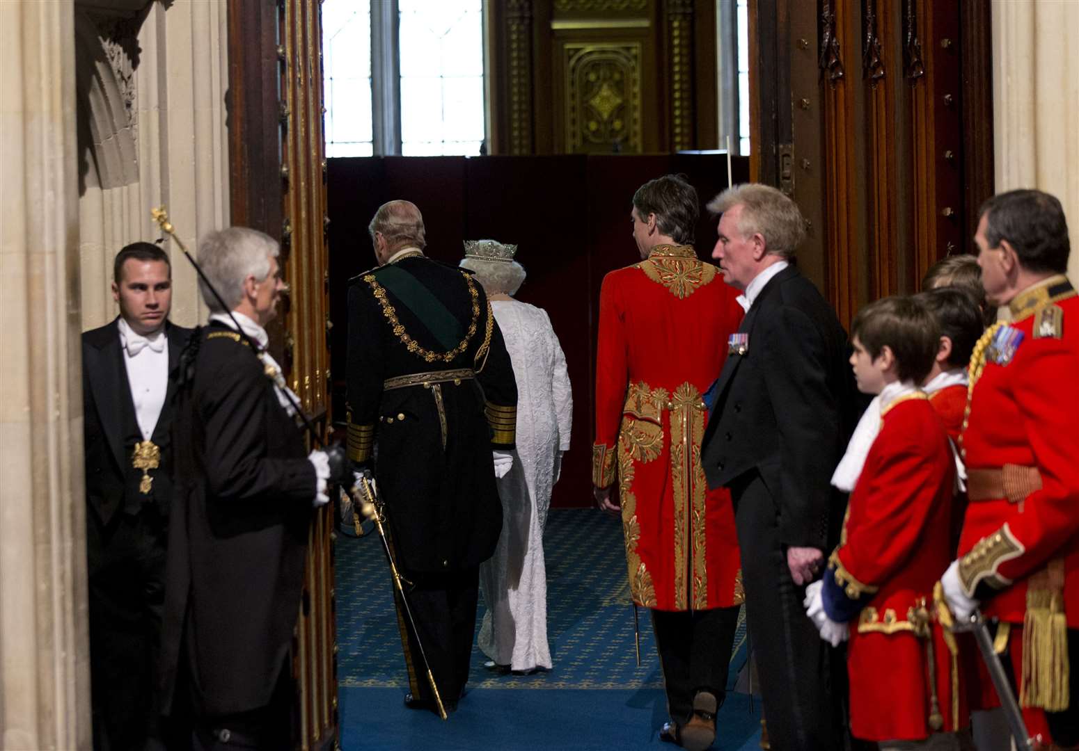 The Queen and the Duke of Edinburgh walk through to the Robing Room, after using a lift, rather than stairs, at the State Opening of Parliament (Yui Mok/PA)