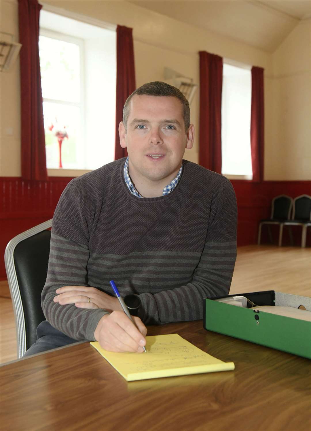 Douglas Ross MP MSP consults his notes after the summer surgery session in Clochan. Picture: Beth Taylor