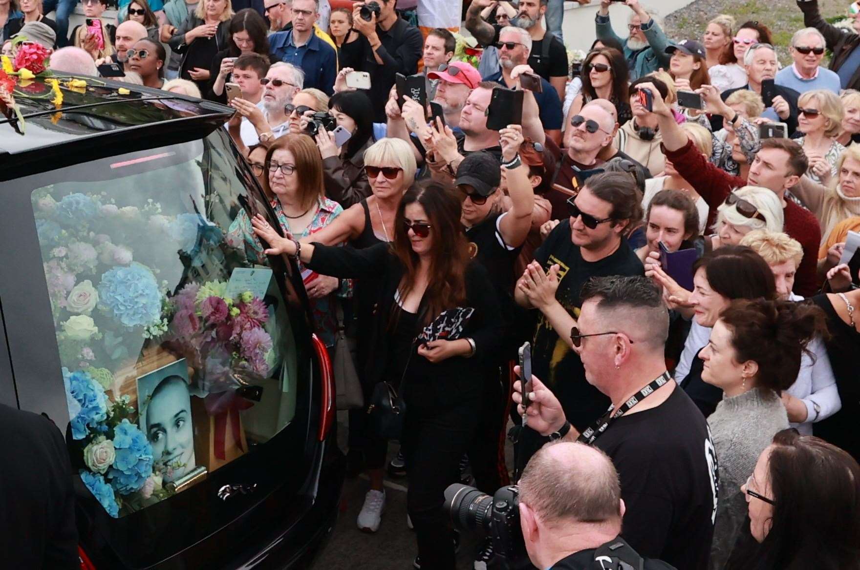 The singer’s funeral cortege passes through her former home town ahead of a private burial service (Liam McBurney/PA)