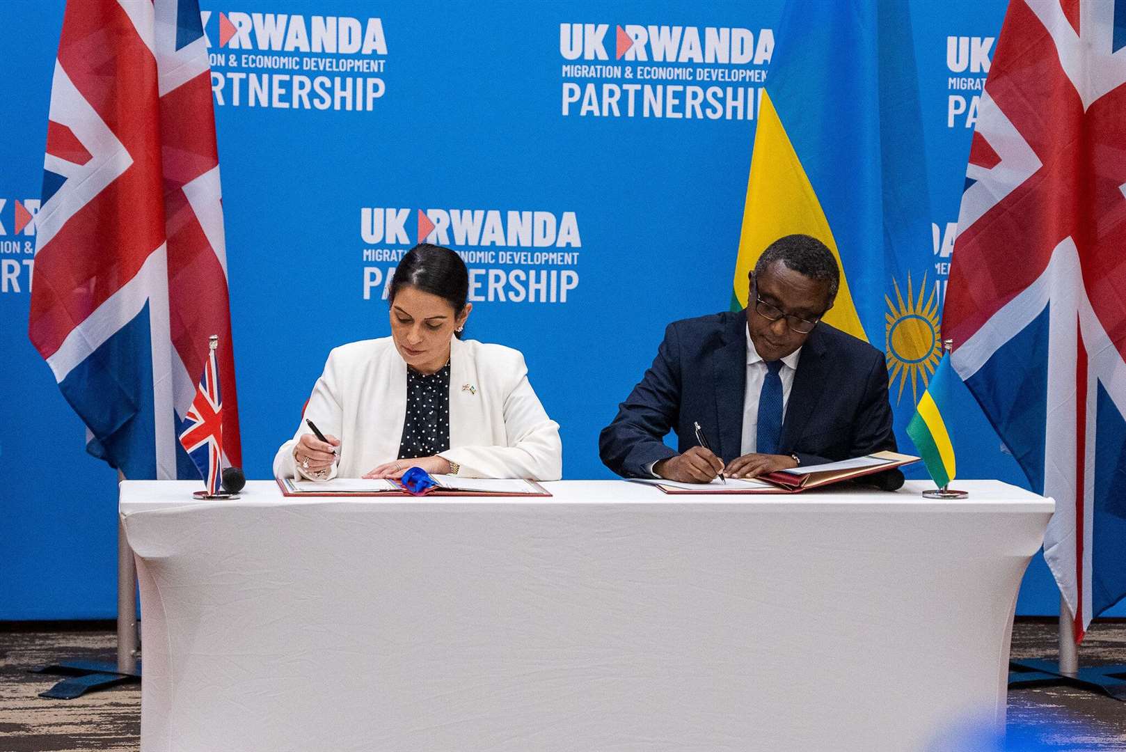 Home Secretary Priti Patel and Minister Biruta sign the migration and economic development partnership between the UK and Rwanda.