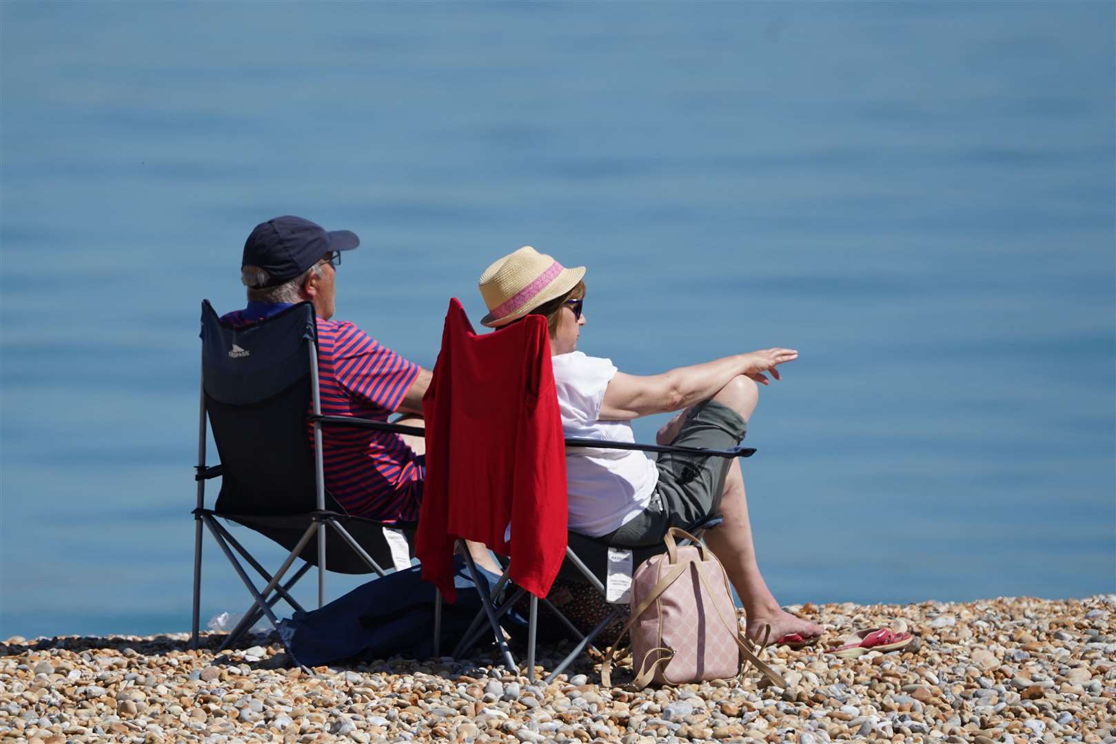 A man and woman enjoying the warm weather on a beach near Dover on May 17 (Gareth Fuller/PA)