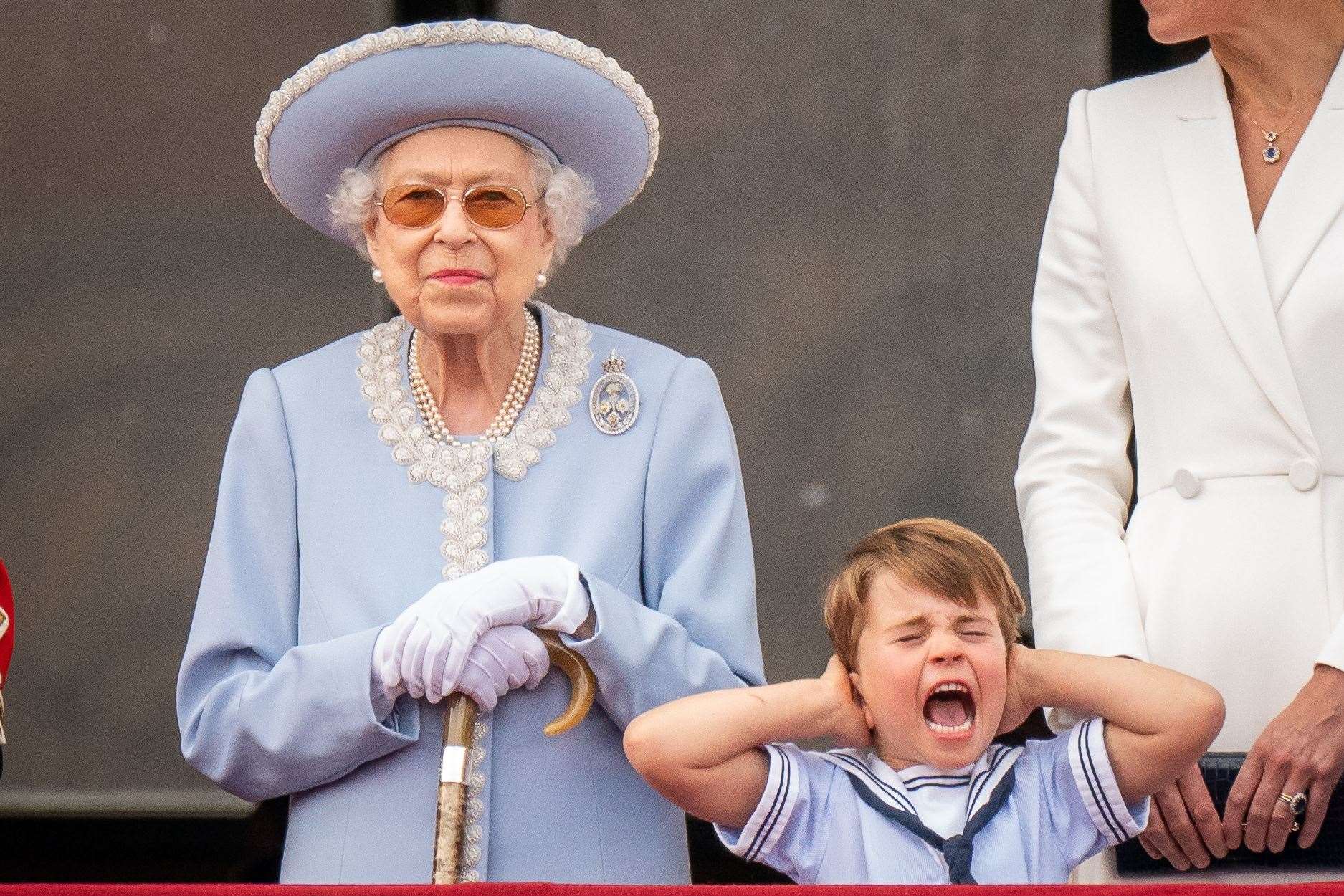 The Queen with Prince Louis as he pulls a face on the balcony of Buckingham Palace (Aaron Chown/PA)