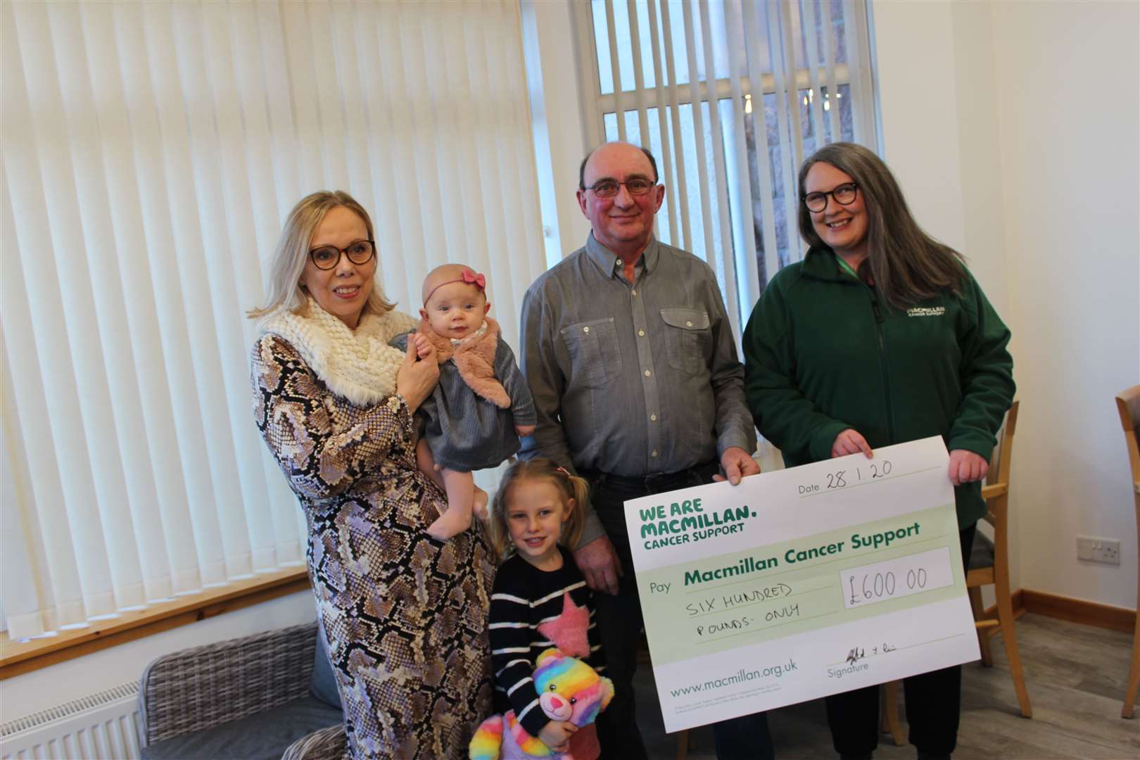 Jayne Pirie, Lucy Massie, Emily Massie and Cliff Pirie presenting the cheque of £600 from their fundraising efforts to Macmillan’s Louise Mackay. Picture: Sean McAngus