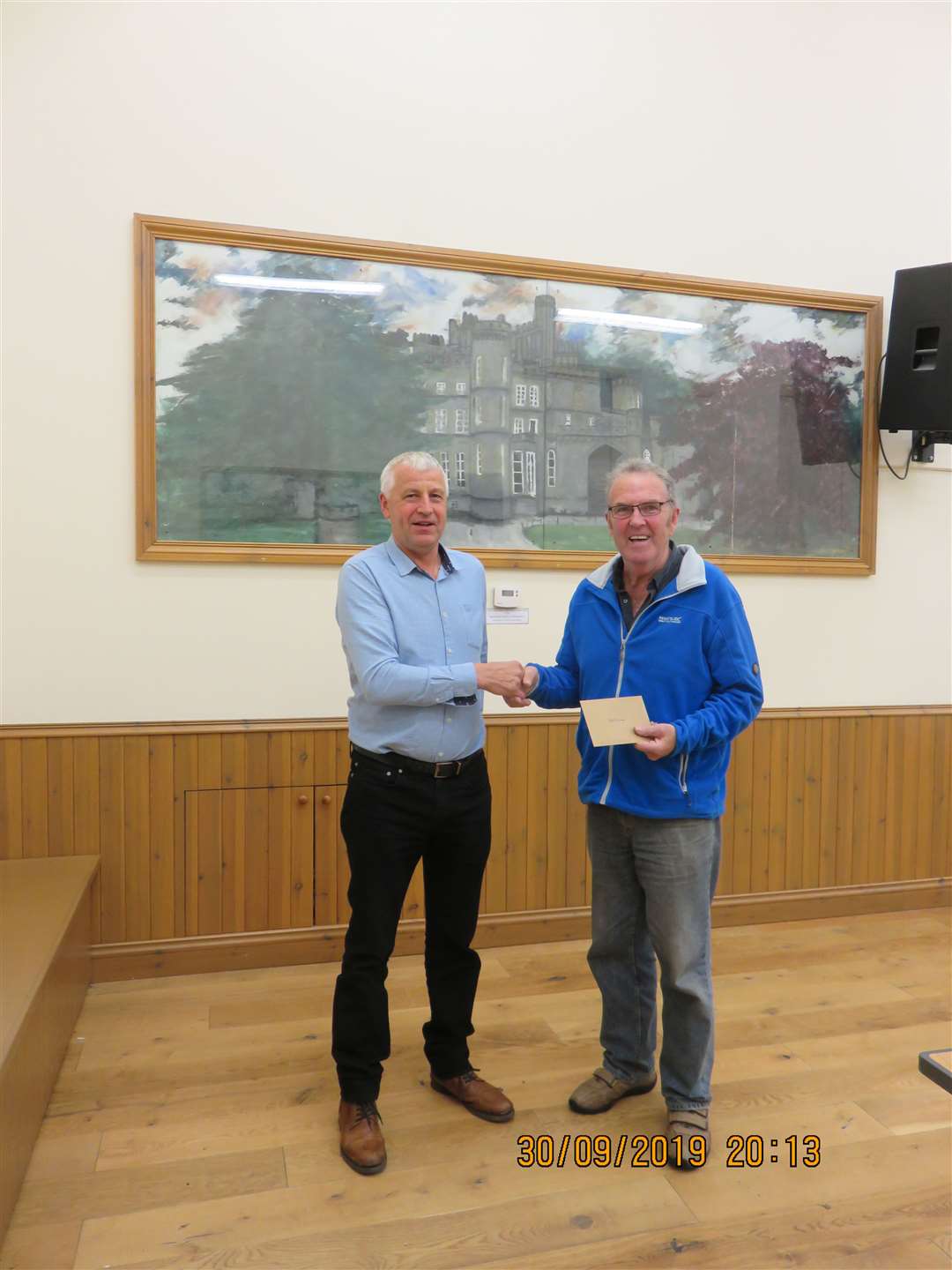 Chairman and fellow Director James Mark presents Peter McWilliam with a gift voucher on his retirement.