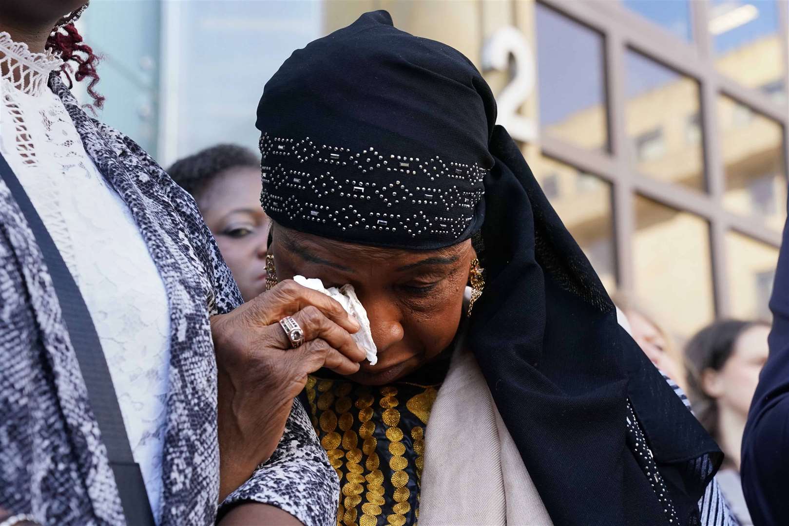 Sheku’s mother Aminata Bayoh wipes her eyes ahead of the start of a public inquiry into the death of her son (Andrew Milligan/PA)