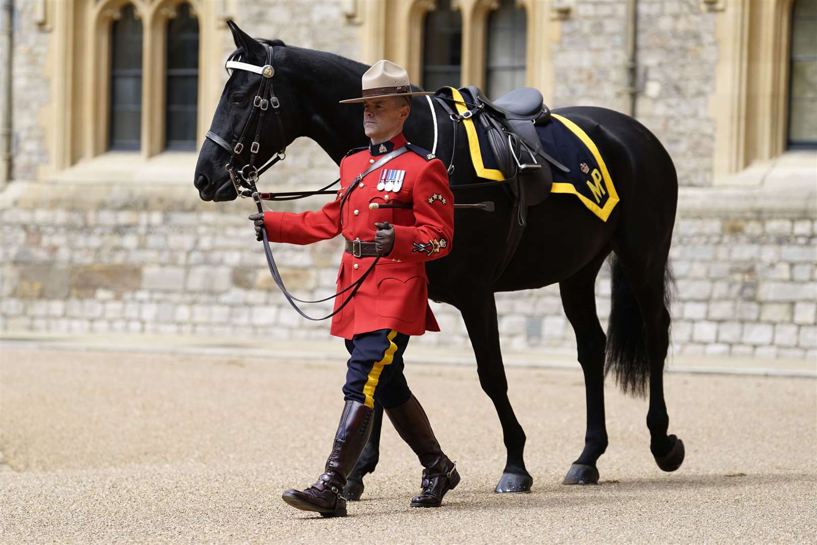 A member of the Royal Canadian Mounted Police leads Noble (Andrew Matthews/PA)
