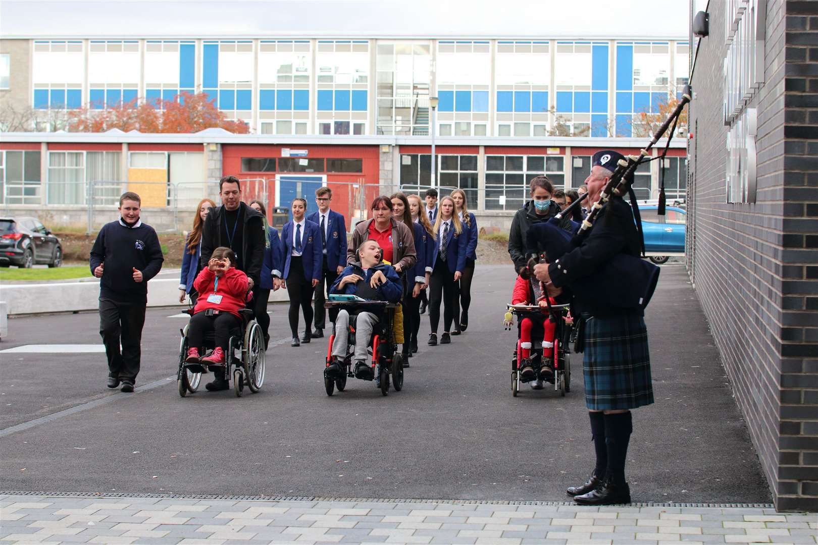 Piper Brian Lynch piped in pupils from Inverurie Academy and St Andrew's to the new campus.