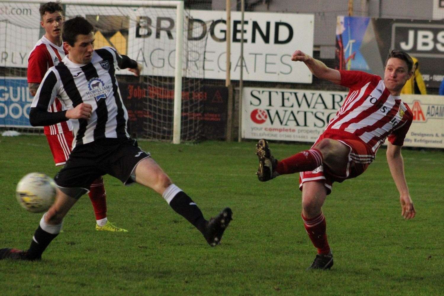 Stuart Smith clears from Paul Campbell. Picture: Ian Rennie