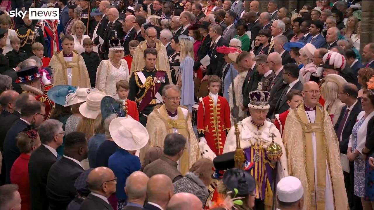 A screenshot of Sky News captures Andrew Simpson (bottom left) as King Charles III passes by.