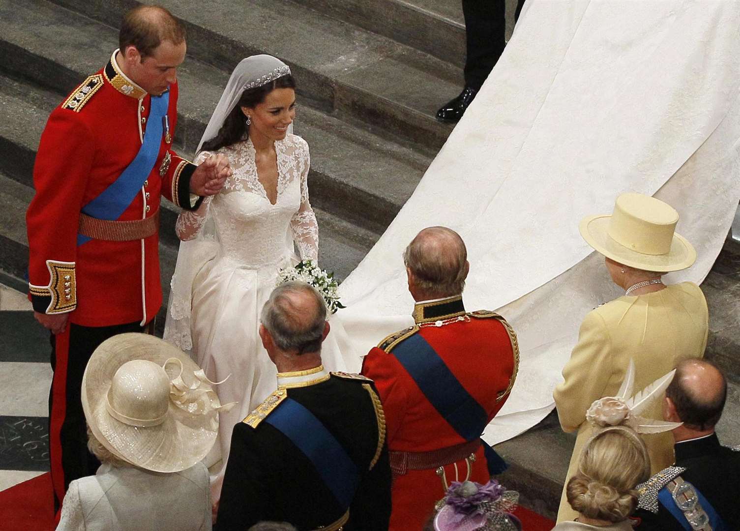 William, in his red tunic, and his new bride Catherine in front of the Queen on his wedding day (Kirsty Wigglesworth/PA)