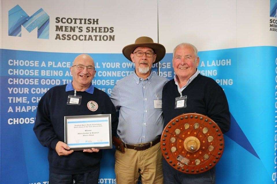 Aberchirder Men's Shed secretary James Paterson, left, Scottish Men's Shed chairman Derek Keiller and Aberchirder's group chairman Mike O'Brien with the award.