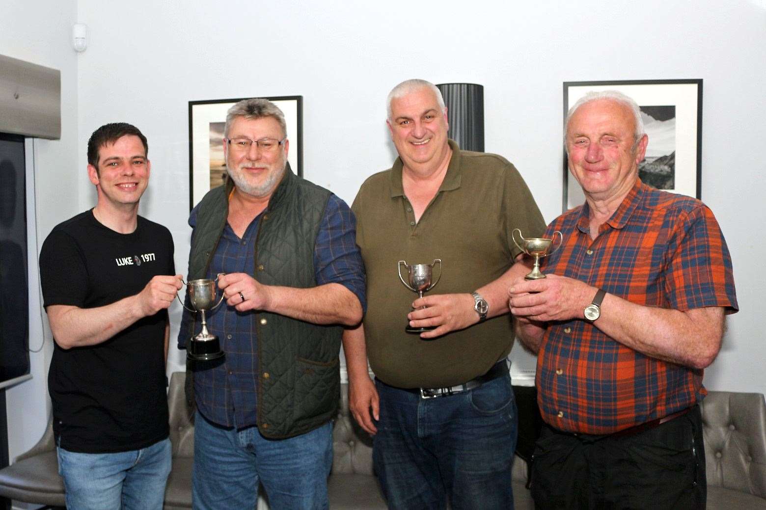 Deveron Camera Club president Barry Riddoch (far left) presents trophies to the group's winners (from left) John Carroll, Jimmy Thomson and Bill Thain. Picture: Andrew Taylor