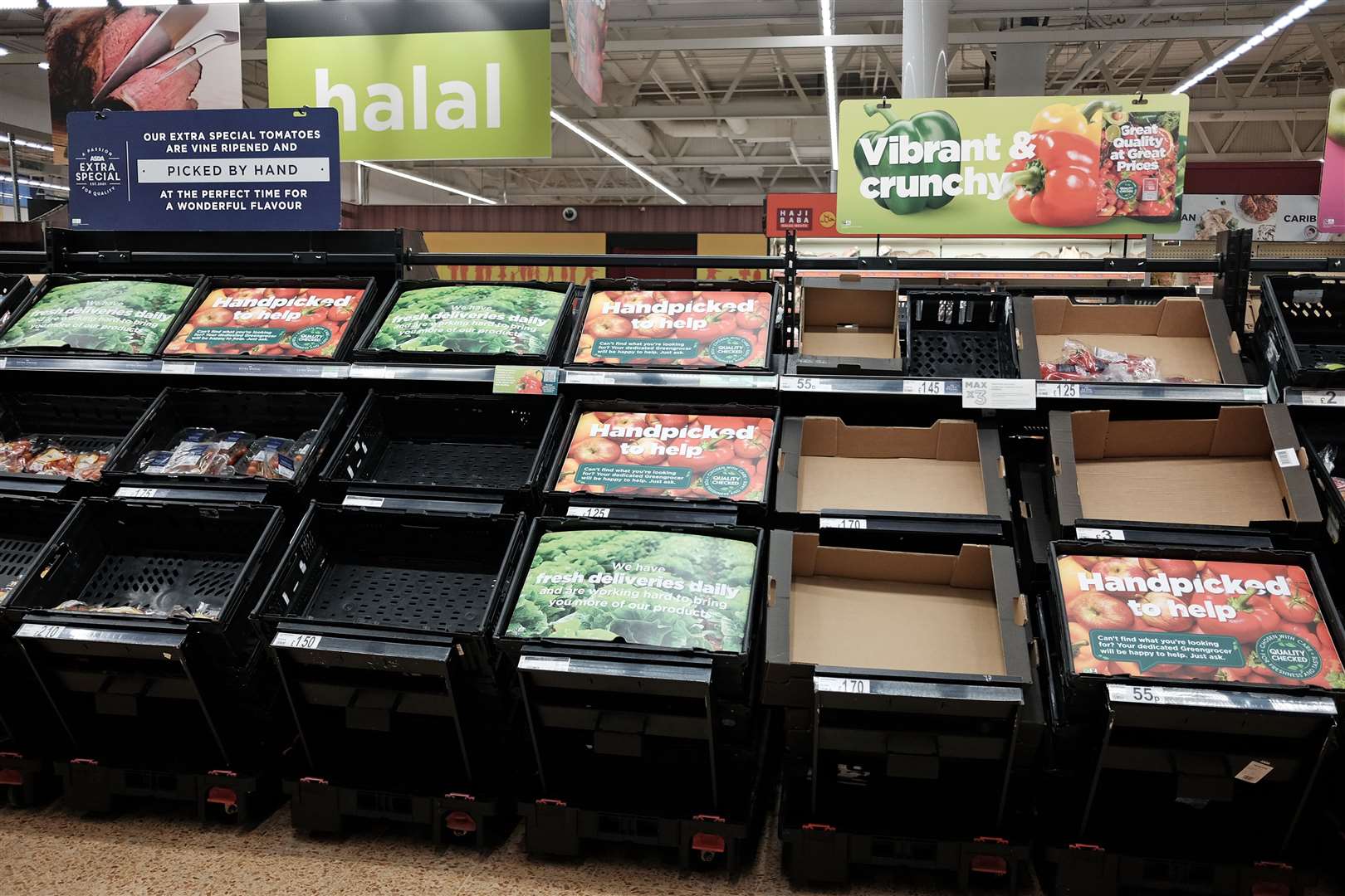 Empty fruit and vegetable shelves at an Asda in east London (Yui Mok/PA)