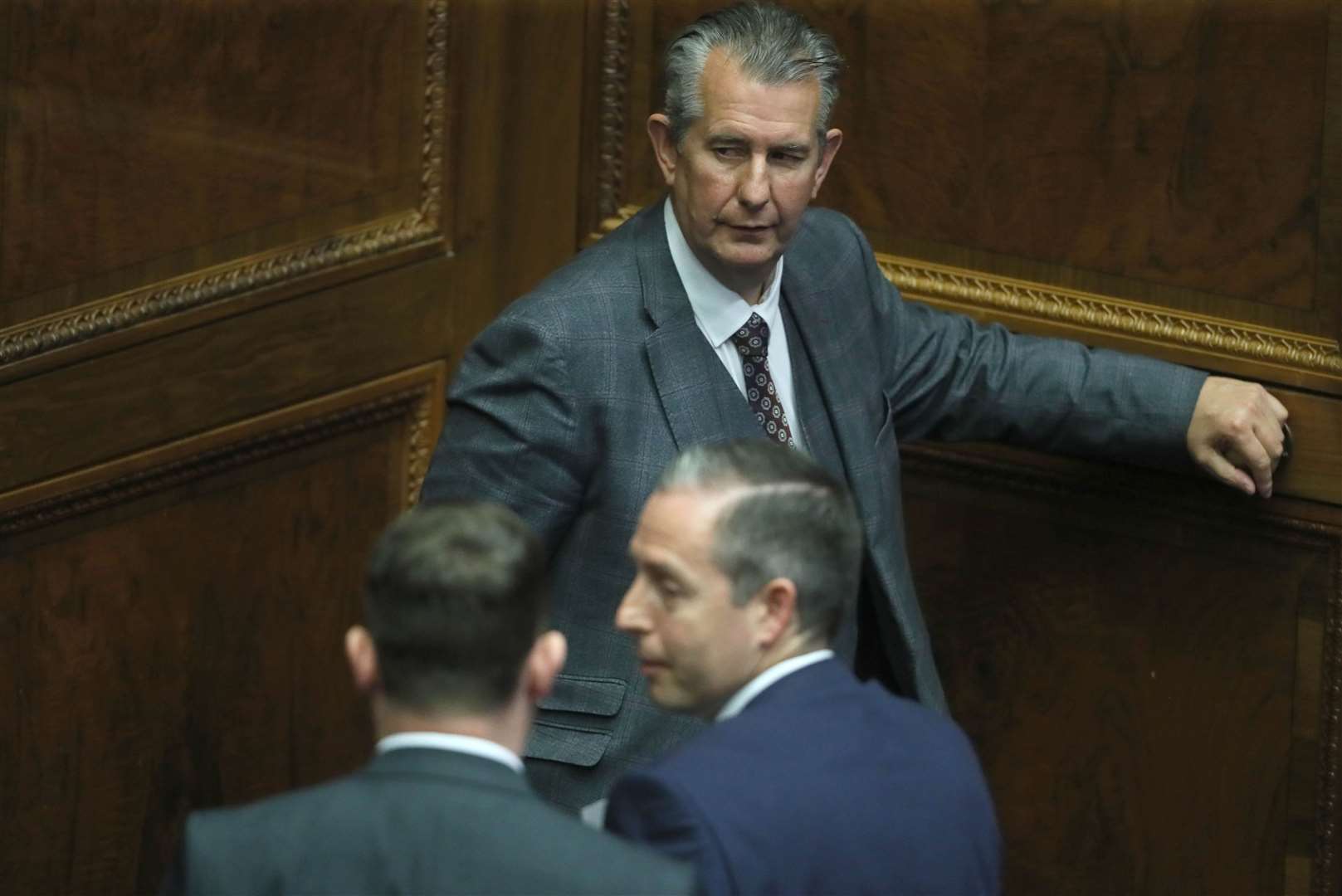Edwin Poots leaving the Assembly chamber after nominating Paul Givan, bottom right, as First Minister hours before resigning as DUP leader (Brian Lawless/PA)