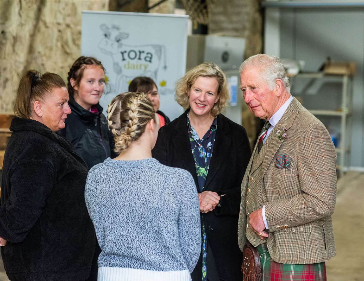 Prince Charles speaks with staff at Rora Dairy.