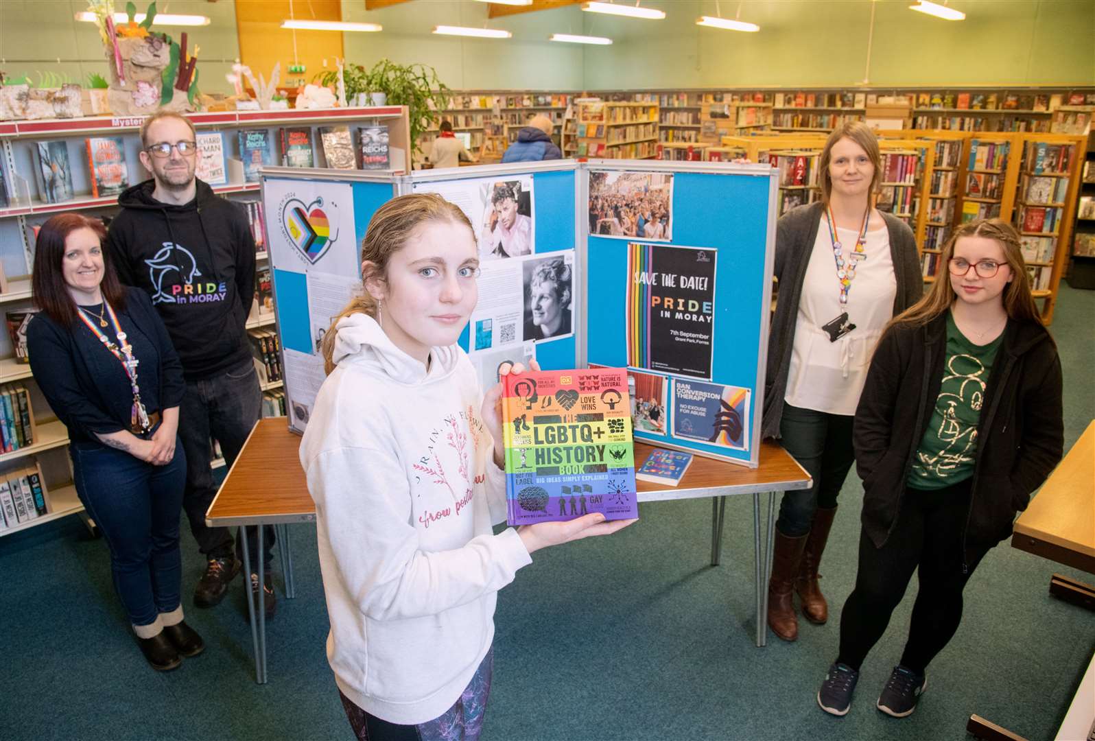 At the exhibition in Forres Library (from left) Emma Matthias (Pupil Support Worker SEBN), David Harrison (Chair of Pride in Moray), Hayley Curran (S3), Dorothy Ross (PT Raising Attainment) and Katie Sommerville (S3). Picture: Daniel Forsyth