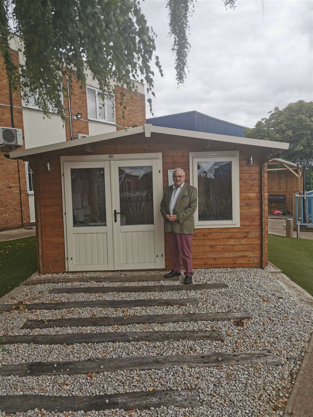 Chris Murphy with one of Dunster House's garden buildings.