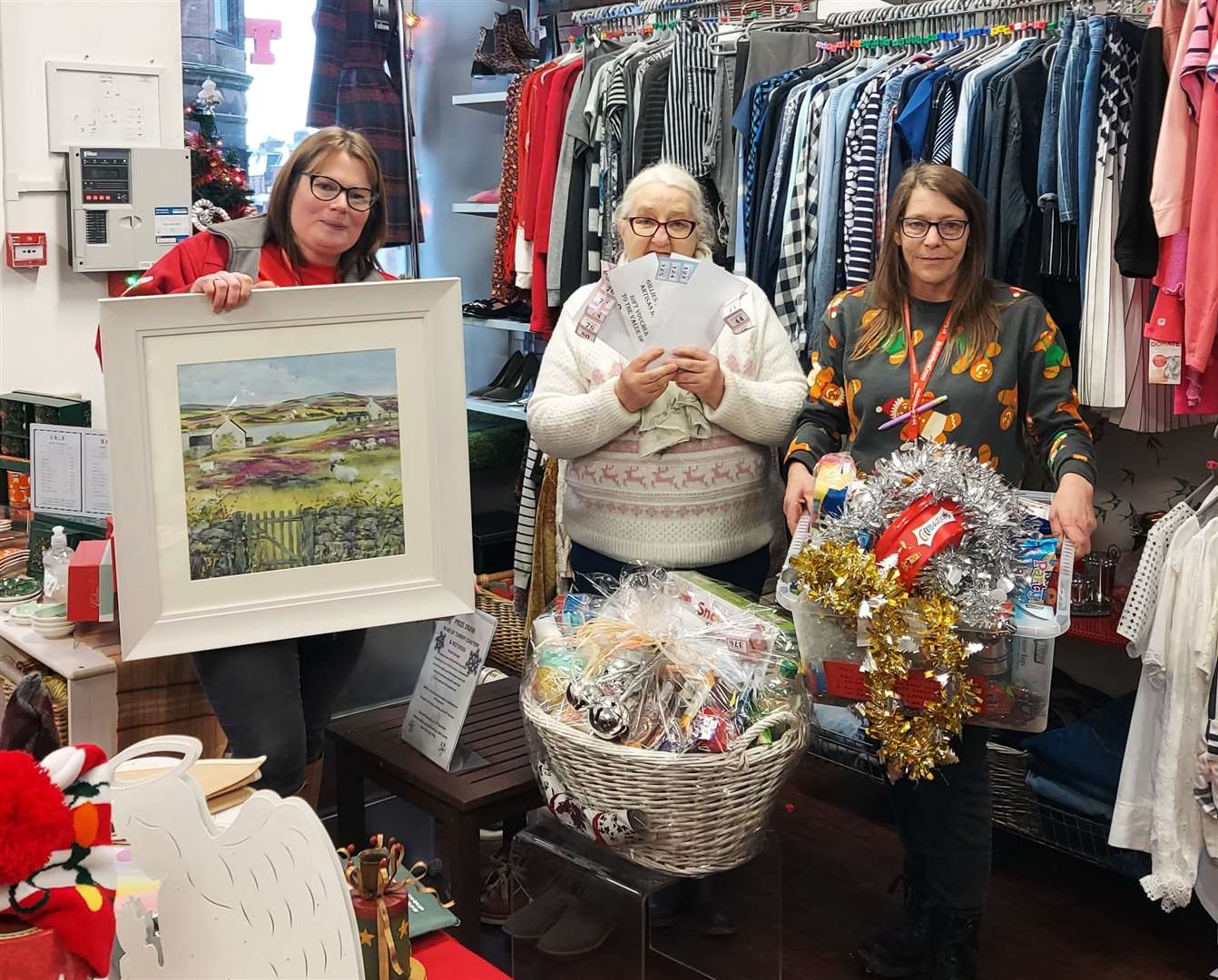 Turriff Red Cross charity shop manager Emma and volunteers Kathleen and Tara drew the winners. Picture: Kirsty Brown