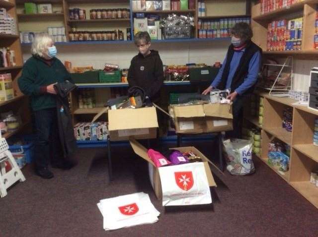 Volunteers opening some of the boxes at the River Church, in Banff.